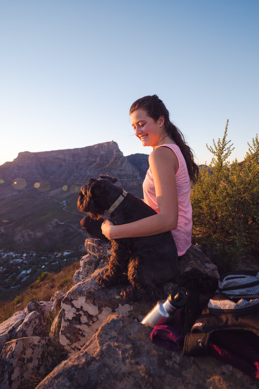 Woman enjoying the view with her dog while hiking